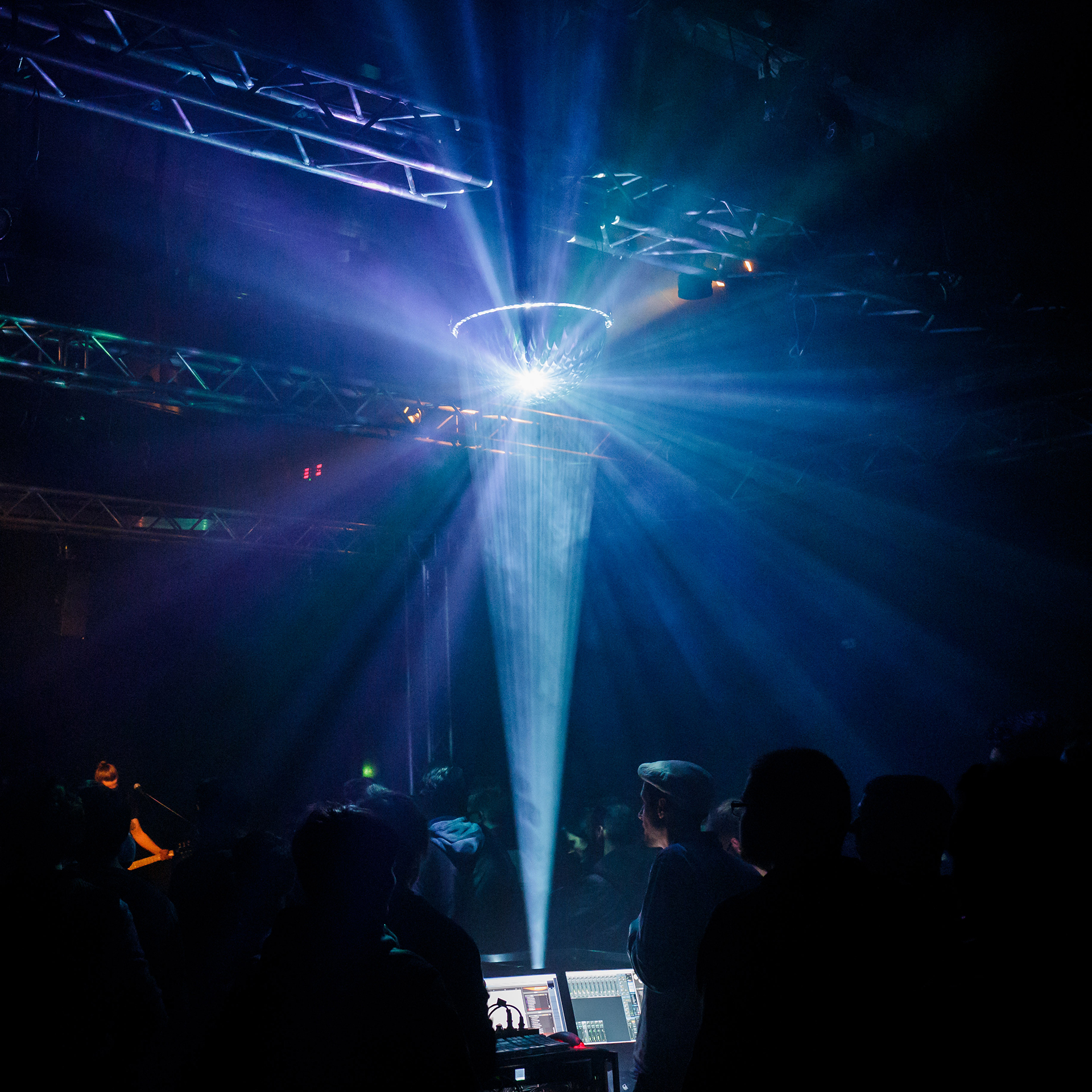Light rays fanning out from the mirrored hemisphere above the audience at the 3D audio concert
