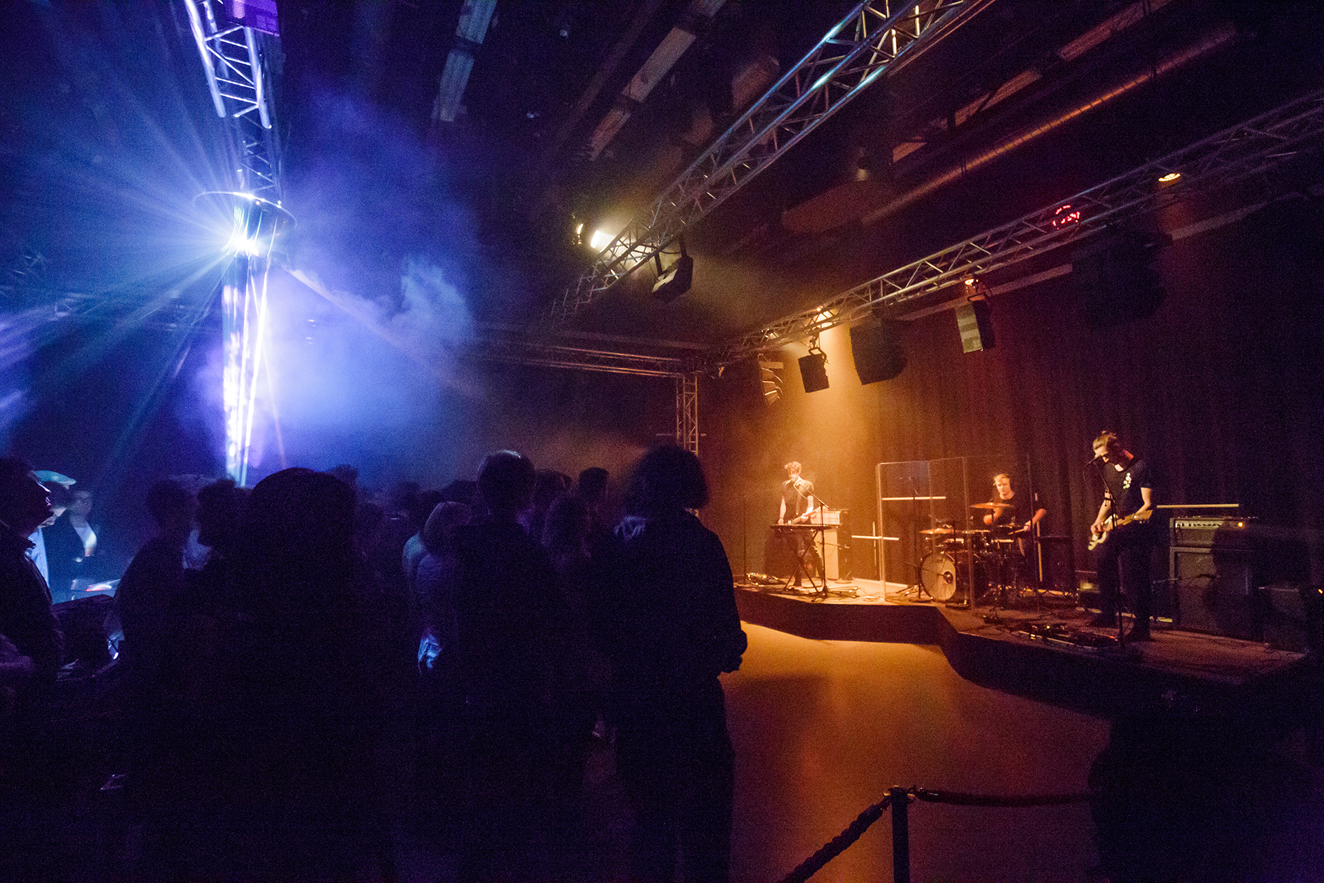 Audience in the room during the Eau Rouge 3D audio concert, mirrored hemisphere glowing on the truss